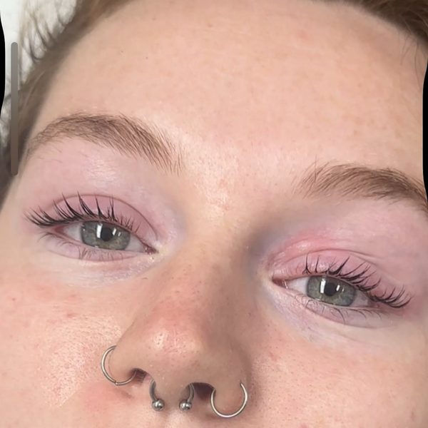Both eyes after a Korean lash lift: lashes lifted and curled from the root, with silver nose jewellery below.
